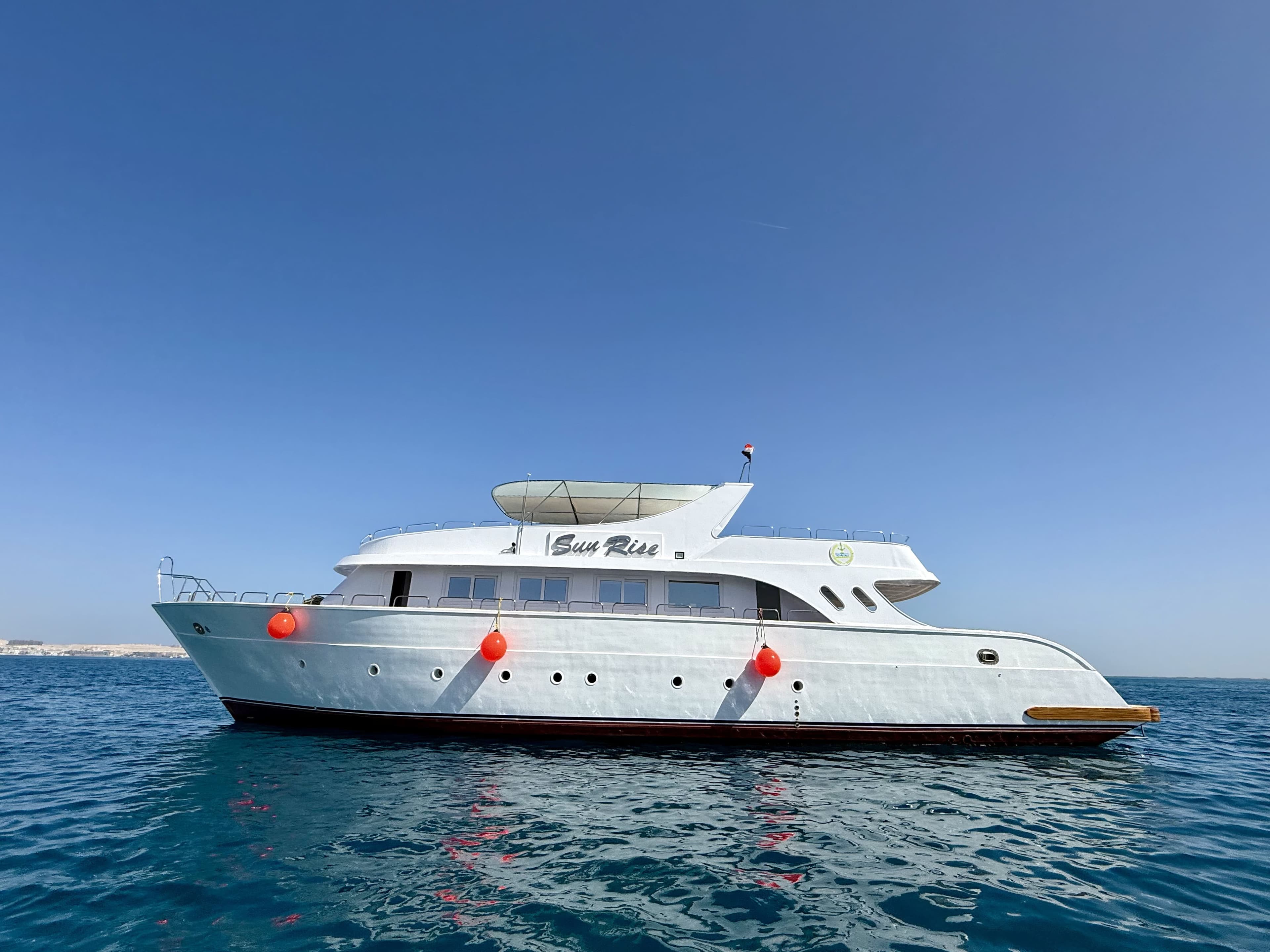 The Sun Rise yacht at anchor on calm turquoise water